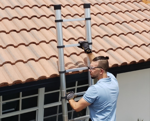 Home inspector on ladder