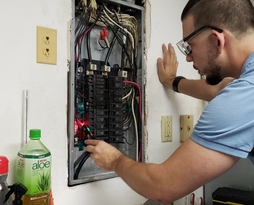 Man inspecting circuit breakers