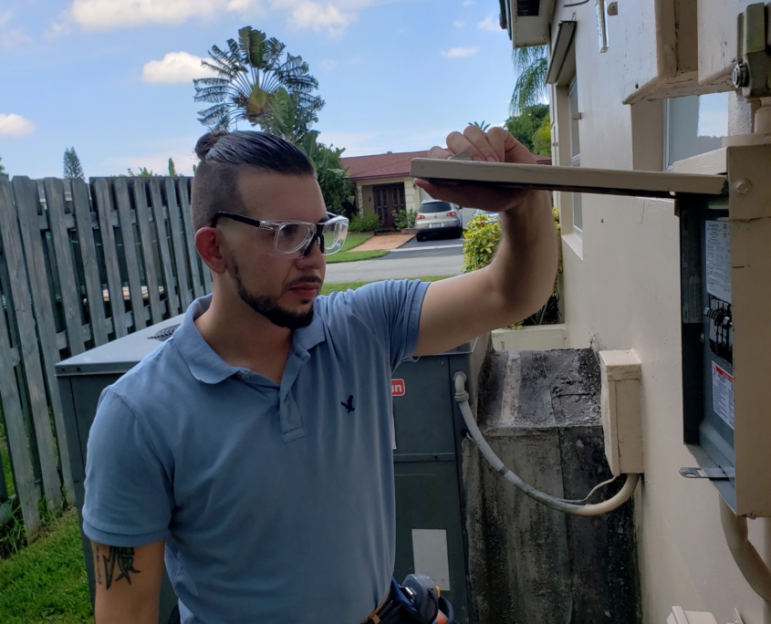 Home Inspector looking at electrical box