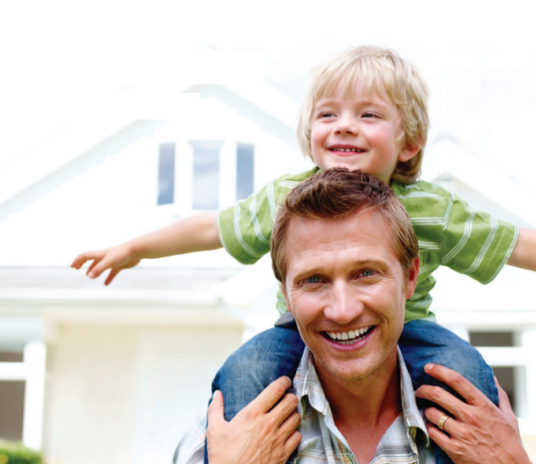 Man riding child on his back